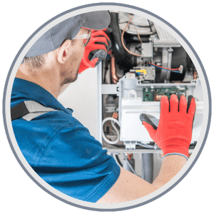 AC & Heating Tune-Up Special 9 HVAC technician calibrating a thermostat during a heating tune-up