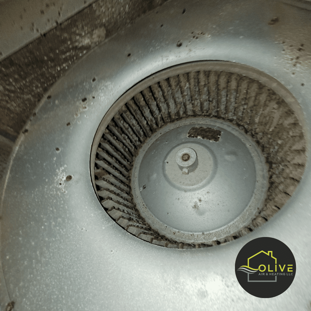 Technician from Olive Air and Heating LLC replacing the faulty fan motor in an AC unit to restore cooling.