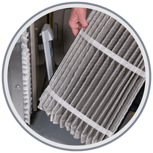 AC & Heating Tune-Up Special 7 HVAC technician replacing a dirty furnace filter during a heating tune-up