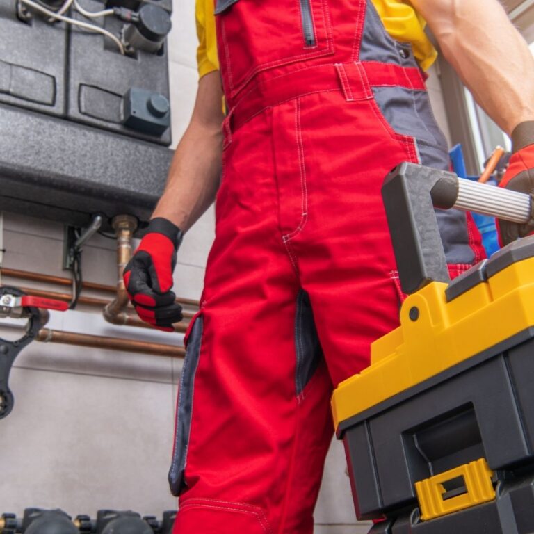 A technician inspecting a heating system component, emphasizing the importance of professional Heating Repair Services in Avondale to maintain a warm and comfortable home.