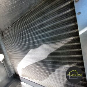 Close-up view of an AC evaporator coil, essential for cooling efficiency. Regular maintenance helps prevent carbon monoxide air conditioning hazards and improves air quality.