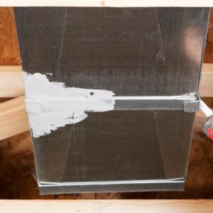 Close-up of an HVAC duct being sealed with mastic, highlighting the importance of proper sealing and understanding Aeroseal duct sealing cost for improved energy efficiency.